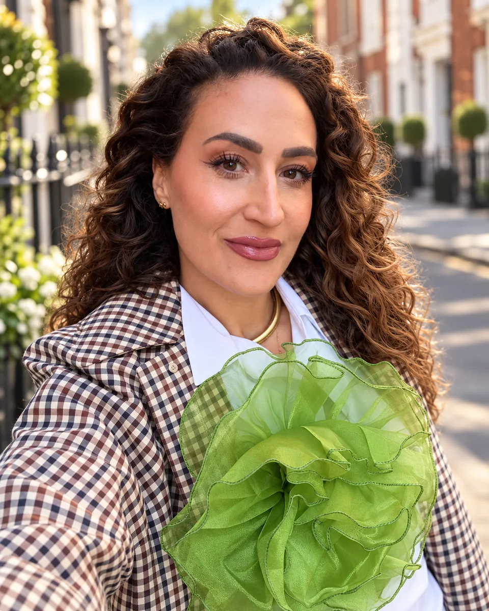 Jenna looking at the camera in a checked jacket with a green floral detail